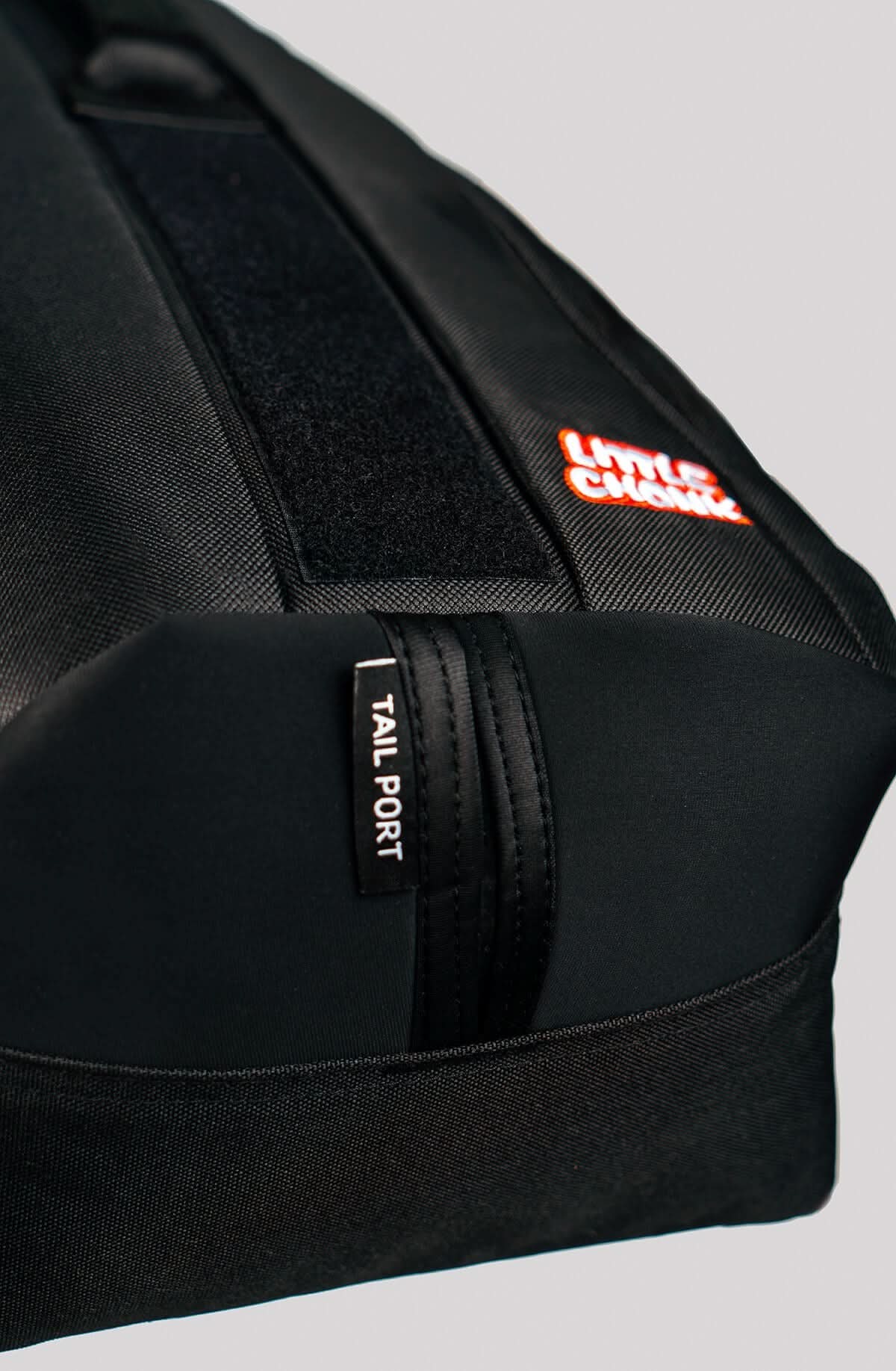 Black Maxine One refurbished fabric backpack with orange little crown logo and tail port zipper pull detail